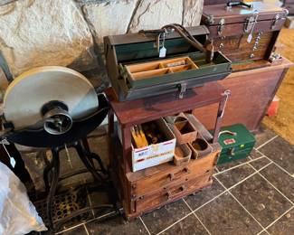 This photo shows a very large grinding wheel (I think, there's so much in the vintage tool arena I don't know), along with a couple of toolboxes.