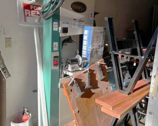 It's a bit challenging to see but there is a Grizzly G0513X 17" Extreme Series Bandsaw behind the other items.