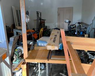 I see a tabletop bench grinder hidden in there, a series of pipe clamps on the back wall, and an articulating lamp.  What else?  Come by to see.