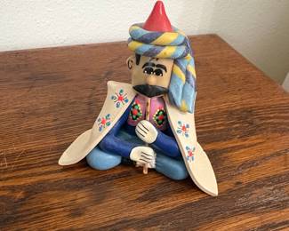 Ceramic Figurine of a Seated Man in Traditional Attire