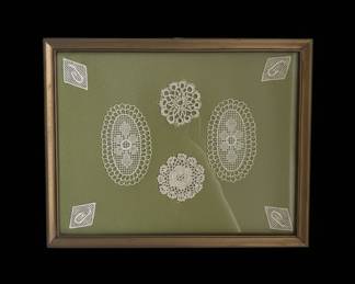 Framed Assortment of White Lace Doilies on Green Background