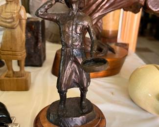 This bronze sculpture, titled "Come An' Get It," is a work by the artist Bob Hunnicutt. 