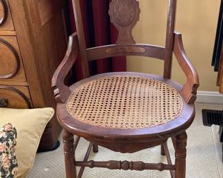 Antique Eastlake Victorian armchair with wicker bottom