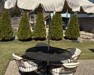 iron patio set with table, four chairs, cushions, umbrella and umbrella stand