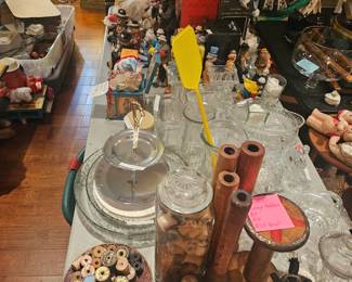A small image of vintage glass items and wood thread spools. A handful of industrial spindles and a spool.
