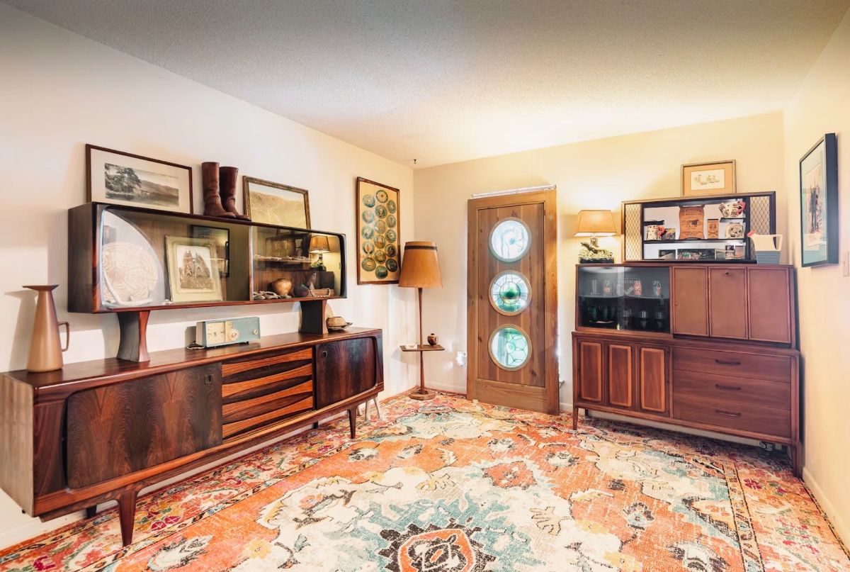 Curated mid-century interiors with custom pieces, rare vintage decor, sculptural wood furniture, and atomic-era design throughout.