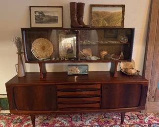 Mid-century Danish rosewood credenza with matching smoked-glass display hutch, circa 1960s. Sculptural tapered legs, sliding doors, and a central bank of louvered drawers. A major statement piece
