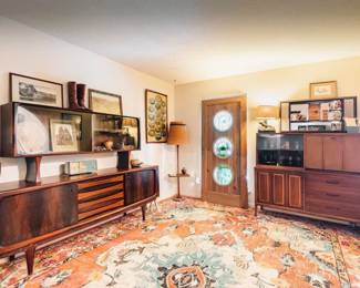 Curated mid-century interiors with custom pieces, rare vintage decor, sculptural wood furniture, and atomic-era design throughout.