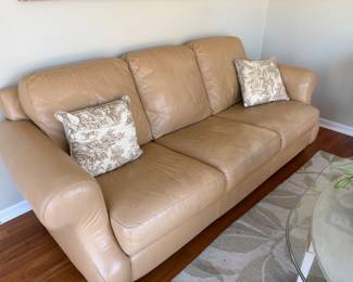 Beige leather sofa with scrolled arms