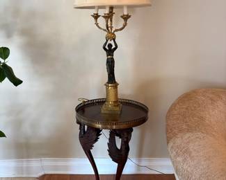 A pair of Empire style galleried tables with a pair of black and gold figural lamps, maybe Frederick Cooper