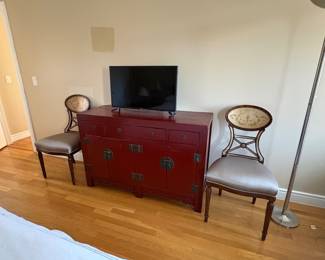 Red Asian style campaign chest and a small flatscreen TV
