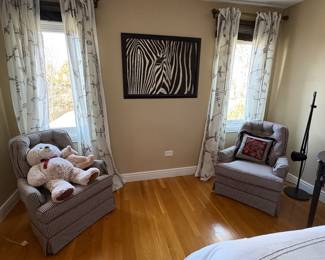 Pair of gray club style armchairs with tufted backs and a zebra painting