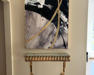 Black, white and gold abstract paining and gold metal console table with black marble top