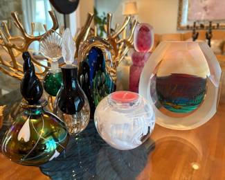 A collection of art glass bottles, paperweights and vases