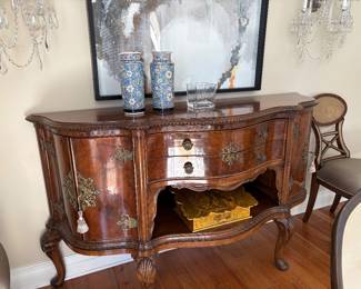 A burled wood bombe shaped sideboard with bronze mounts