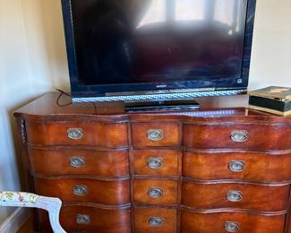 Chippendale style chest with drawers and a flat screen TV