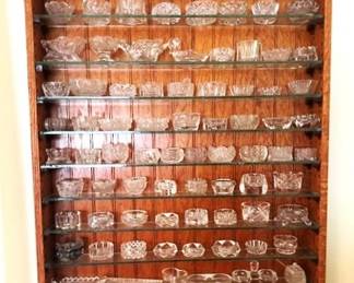Large collection of "Salts" or "Salt Cellars" with unique wall shelf.