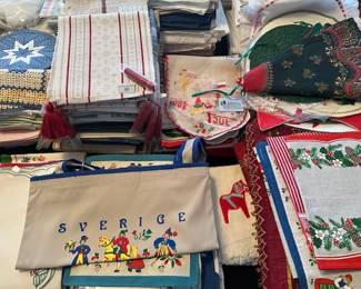 Scandinavian=style textiles, including embroidered cloths, napkins, aprons, hand towels, table cloths, etc.