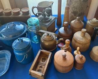 Vintage and antique primitives, including blue speckled enamelware, wooden butter molds, copper kettles and various stoneware.