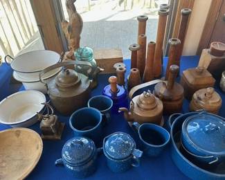 Vintage and antique primitives, including blue speckled enamelware, wooden butter molds, copper kettles and various stoneware.
