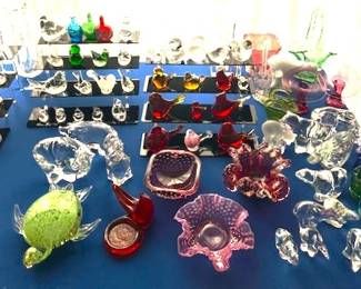 Large collection of colorful artisan-style glass figurines and decorative bowls.