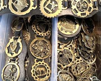 Vintage horse brasses anda few mounted on leather straps.