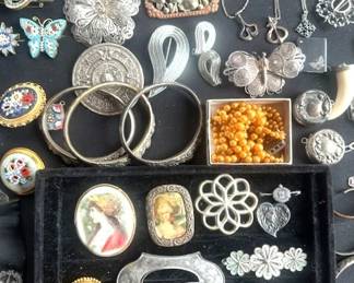 Antique and Vintage jewelry items, including sterling brooches, necklaces, bracelets and cameo pins.