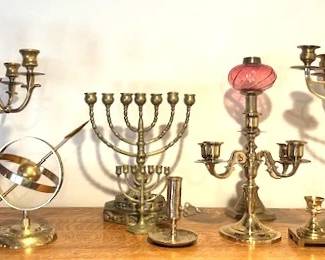 Various antique and vintage brass candelabras, including Menorahs.