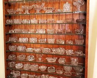 Large collection of "Salts" or "Salt Cellars" with unique wall shelf.