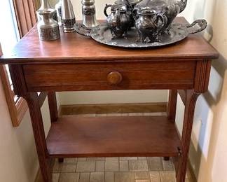 Vintage end table  with Scandinavian pewter vases and candle holders and silver-plated tea/coffee service.