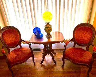 Set of Antique Victorian-era Louis XV style armchairs upholstered in red velvet-like fabric and a antique pedestal table.