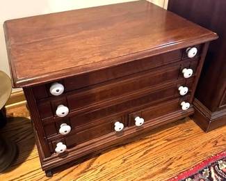 Antique wooden spool cabinet.