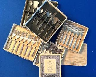 Antique silver plated forks and serving pieces in their original boxes.