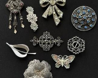 Collection of Vintage brooches, dress clips and earrings.