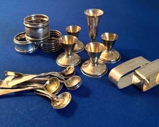 Sterling silver napkin rings, miniature spoons and Russian liqueur vodka cups.