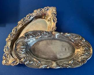 Art Nouveau-style floral and foliate motif silver-plated serving trays.