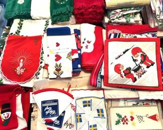 Scandinavian=style textiles, including embroidered cloths, napkins, aprons, hand towels, table cloths, etc.