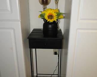 Small black table with some great glass candle sticks and some sunflowers too