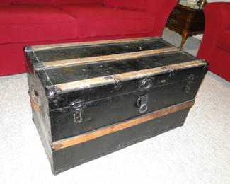 Travelers trunk.  The red sofas ARE NOT FOR SALE