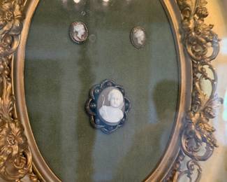 The framed cameo and buttons depicted on the sitter are present and will accompany the portrait in the sale.