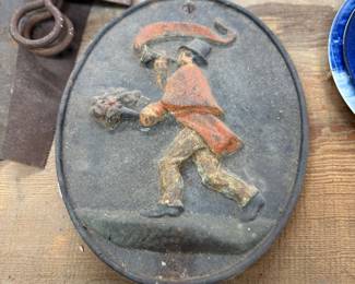 A vintage cast iron fire mark plaque designed to be mounted on a building to signify fire insurance coverage.