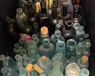 A large collection of antique bottles.