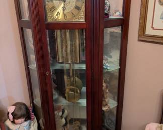 Grandfather clock with integral shelving. Keeps correct time.