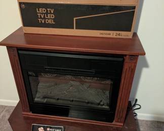 Two pc fireplace, top removes, has wheels and serves as heater