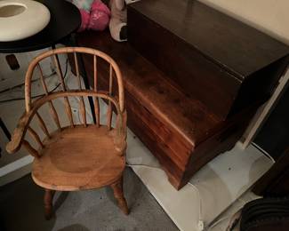 Vintage cedar chest, primitive storage box, and antique wooden child’s armchair.