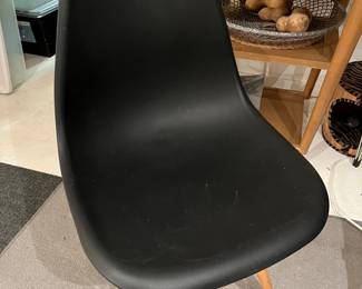 Eiffel chair with molded plastic seat and wooden legs.