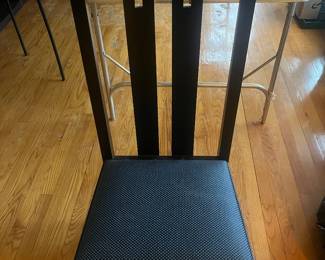 Closer view of one of the four chairs made in Italy by AI (Atelier International Limited).