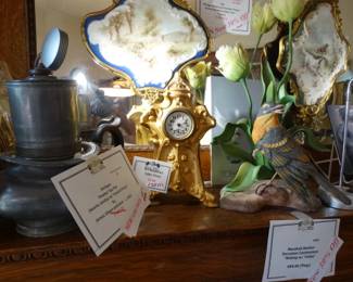 On the mantle: a rare pr. of hand painted wall  plaques in fancy frames byWavecrest- a pewter tea pot by James Dixion (1821) a Small Gilt Art Nouveau able Clock & a Marshall Boehm Pporcelain Centerpiece "Robin w/ Tulips"