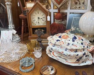 English ironstone soup tureen with matching lid and tray, antique mirror, metal door knocker, clock, chair