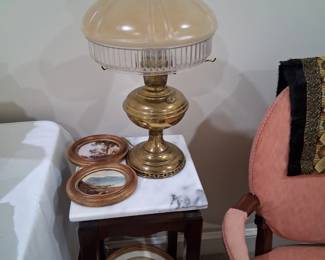 this antique oil lamp went through a fire in Illinois in the early 1900s then was restored as an electric lamp